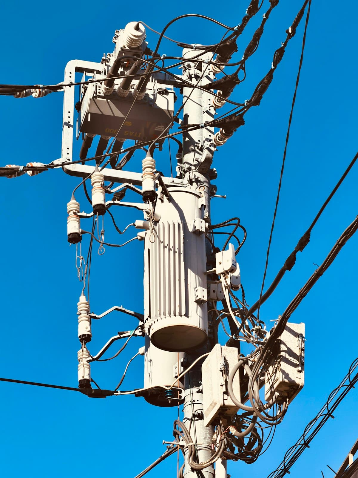 High-voltage transformer installation on a utility pole